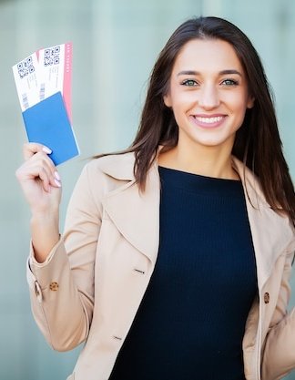 travel-woman-holding-two-air-ticket-abroad-passport-near-airport_118454-6276